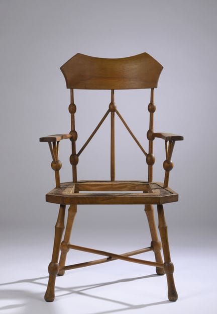 GERMAN FURNITURE, 1900
Light oak armchair with a b