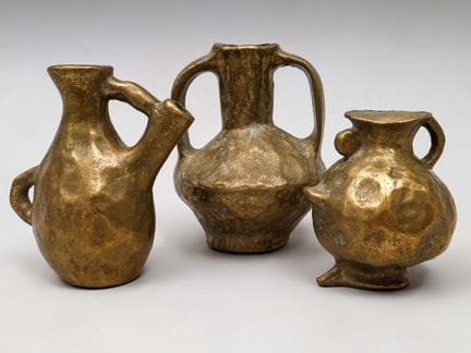 Tres jarrones de formas toscas en bronce dorado. H