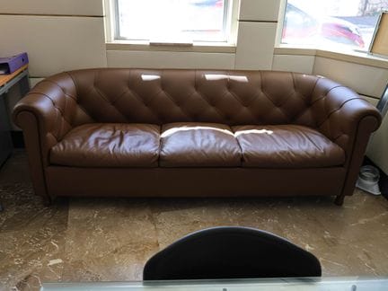 Brown faux leather tufted "Chesterfield" sofa