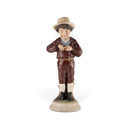 A LARGE BISCUIT PORCELAIN FIGURE 'BOY WITH AN ORAN