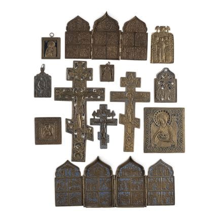 A COLLECTION OF TWELVE BRASS ICONS DEPICTING CRUCI