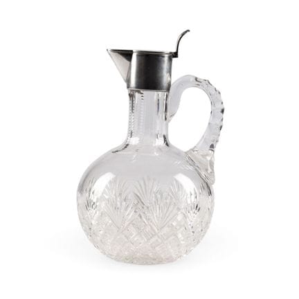 A SMALL GLASS DECANTER WITH SILVER MOUNT AND ENGRA
