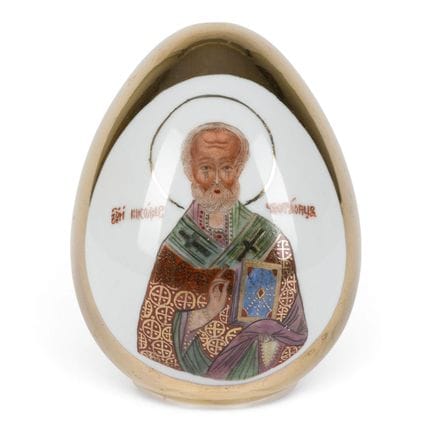 A PORCELAIN EASTER EGG SHOWING ST. NICHOLAS OF MYR