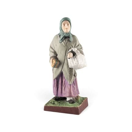 A BISCUIT PORCELAIN FIGURE 'AN OLD JEWISH WOMAN' R
