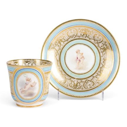 A PORCELAIN CUP AND SAUCER WITH PUTTI Probably Rus