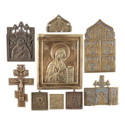 A COLLECTION OF NINE BRASS ICONS DEPICTING CRUCIFI
