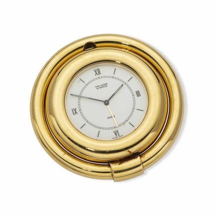 VAN CLEEF & ARPELS 
GILT BRASS ROUND TRAVELING CLO