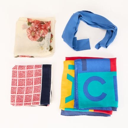 Group of four luxury scarves. Including two Chanel
