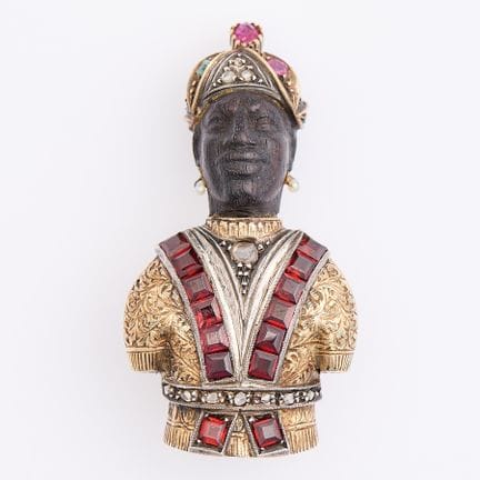 14K黄金胸针，造型为黑人（Blackamoor 或 Moretto），面部和躯干由雕花乌木制成，表