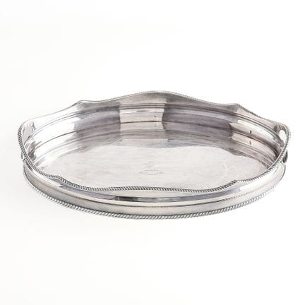 Silver plate oval serving tray featuring a decorat