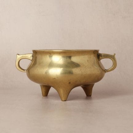 A Chinese polished bronze tripod censer, Qing dyna