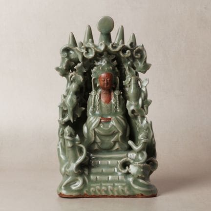 A Chinese celadon-glazed biscuit 'Guanyin' figure 