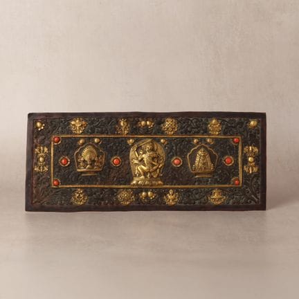A Tibetan parcel-gilt copper-alloy coral-inlaid re