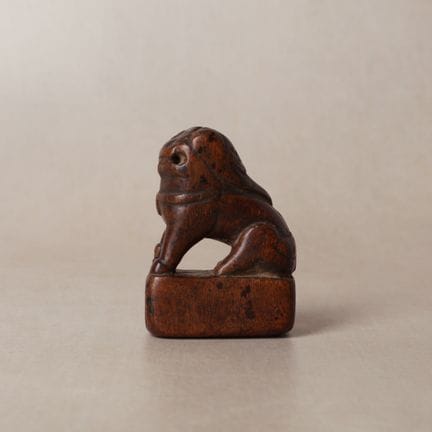 A Chinese carved boxwood 'seated lion' seal, 17th/