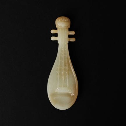 A Chinese celadon and russet jade 'pipa' group, 18