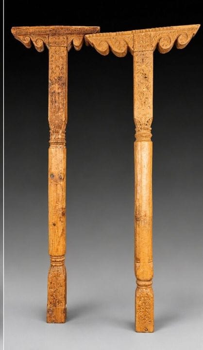 Two carved pine columns with consoles decorated wi