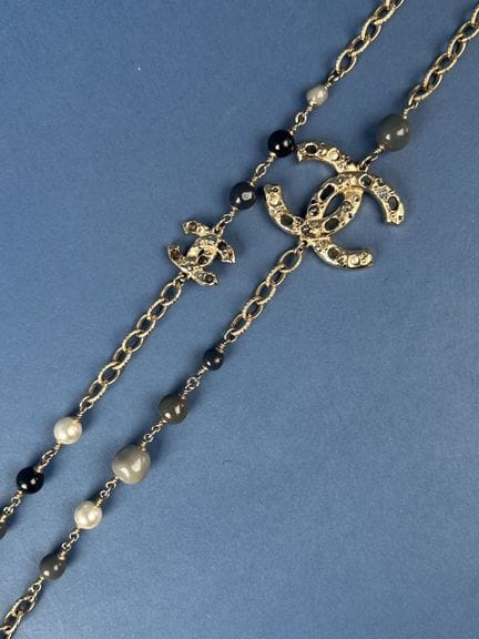 CHANEL 
Long necklace featuring hammered, beaded g