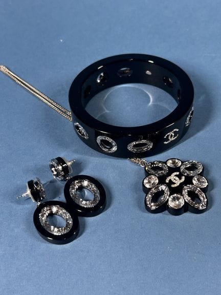 CHANEL 
Black resin set featuring cut-out circles 