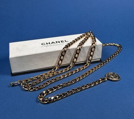 CHANEL
Three-row gold-tone metal chain belt that d