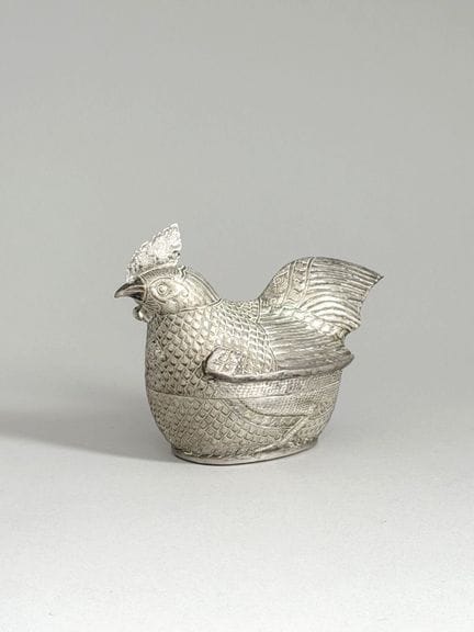 Silver box with a low-relief design in the shape o