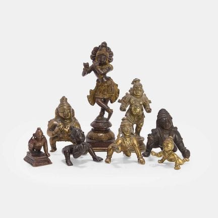 A collection of Indian brass Bala Krishna figures,
