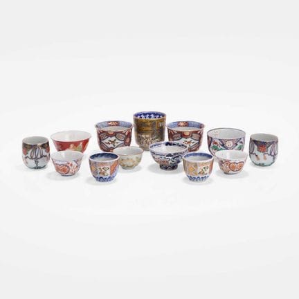 A collection of thirteen Japanese porcelain cups, 