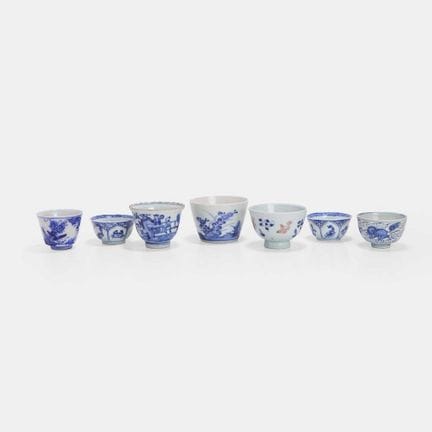 A collection of seven Japanese blue and white cups