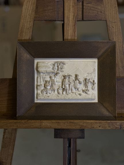 SMALL STONE BAS-RELIEF inscribed on the back with 
