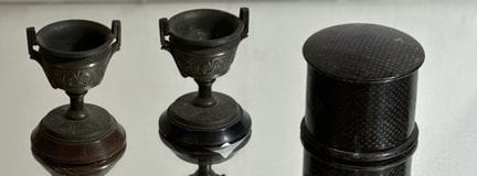 Set includes: 
TWO EGG CUPS made of black-patinate
