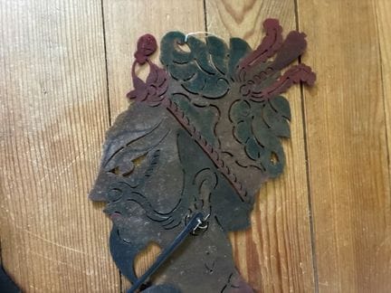 TWO PERFORATED LEATHER SHADOW PUPPETS depicting a 