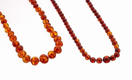 Lot 2 amber-chains , 1 x out of round amber-sphere