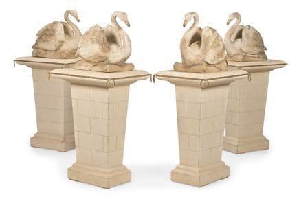 A SET OF FOUR CARVED WOOD AND PAINTED SWANS ON PED