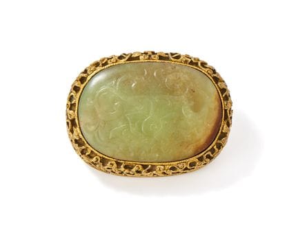 Eine ovale Gürtelschnalle aus gelber Jade und verg