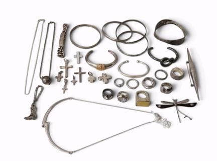 A collection of silver jewelry in various fineness