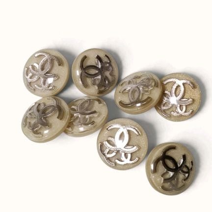 CHANEL. Set of eight round, domed buttons made of 