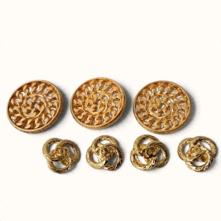 CHANEL. Set of seven vintage gold-tone metal butto
