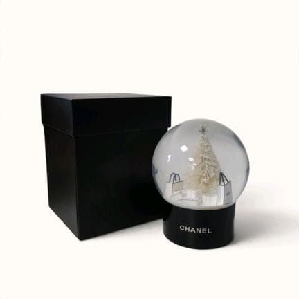 CHANEL. Snow globe featuring a snow-covered Christ