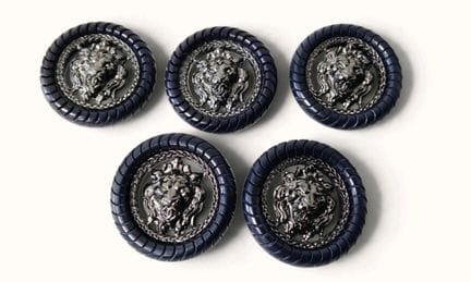 CHANEL. Set of five navy blue round buttons with a
