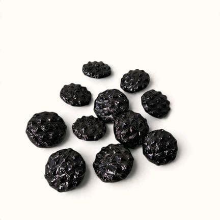 CHANEL. Set of eleven round, domed black metal but