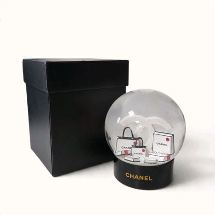 CHANEL. Snow globe featuring a stylized, glittery 