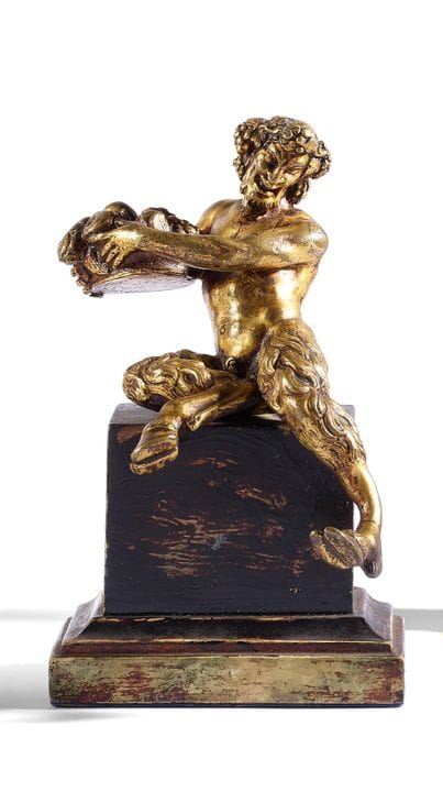 A bronze figure with a golden patina in the style 