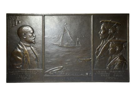 Patinated bronze plaque titled *Le SET*, a memento