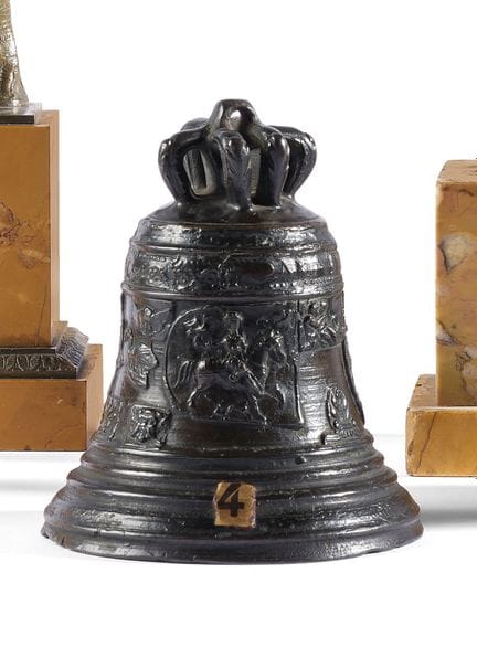 Bronze bell with a dark patina; the body bears the
