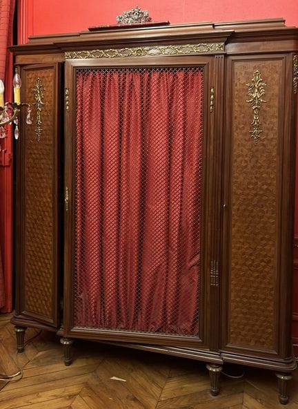 A bookcase made of veneered wood with inlaid cubes