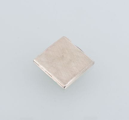 Square silver powder compact (800 mil.) with a bru