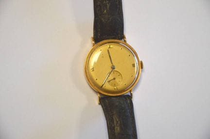 Herrenarmbanduhr aus Gelbgold (18kt 750°),
Lederar