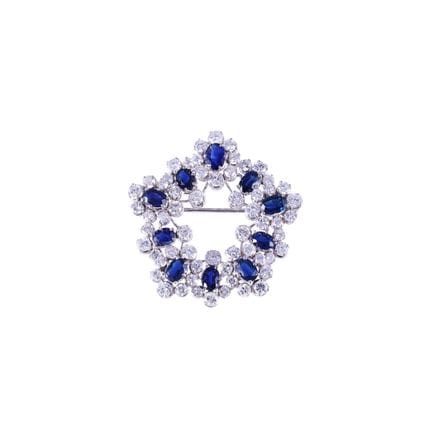 BROCHE en or blanc 18 carats de forme circulaire, 