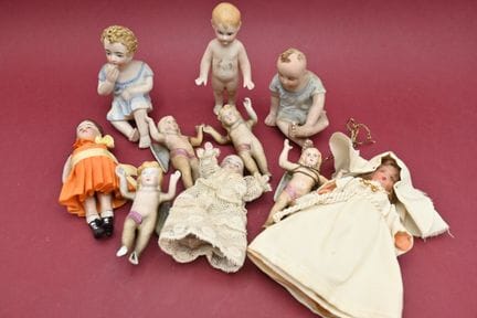 十只各式各样的小玩偶，包括瓷质钢琴玩偶、领圣体的小女孩、瓷质天使（翅膀断了）。
高度：7至9厘米。

