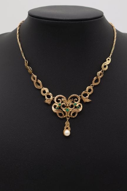 Gold necklace with colored stones and central pear