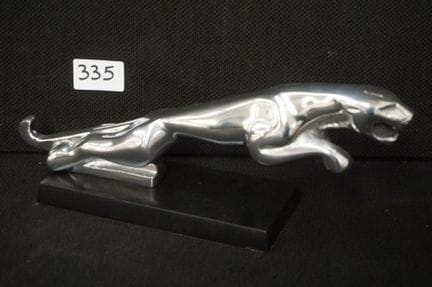 Chrome-plated statue on a pedestal - JAGUAR emblem